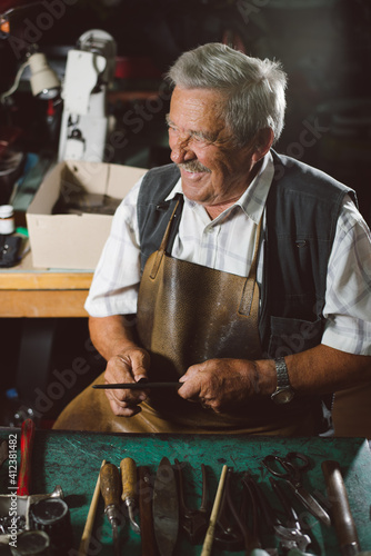 Wallpaper Mural Smiling Senior Shoemaker Working At His Desk Torontodigital.ca