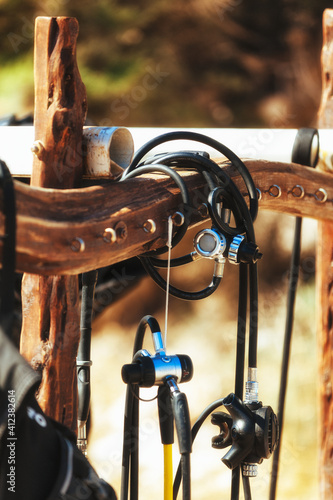 Diving equipment hanging on the wooden stand photo