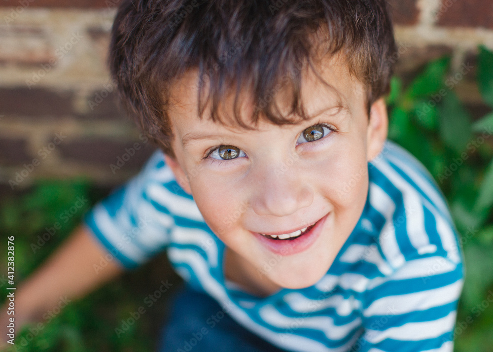 Looking down on a young boy smiling brightly Looking down on a young boy smiling brightly