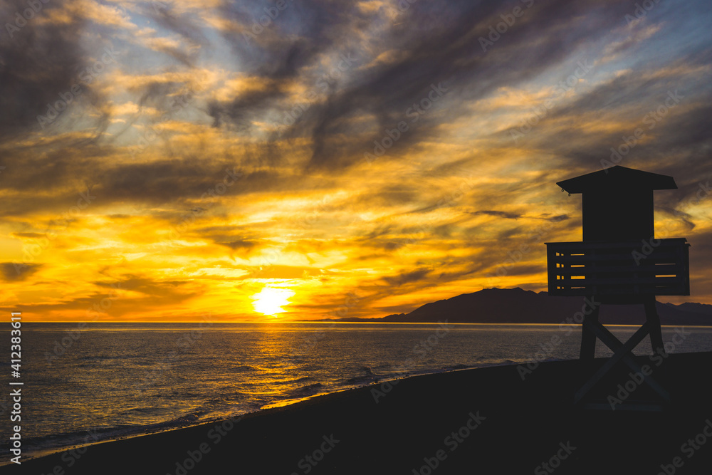 The ocean rescue lifeguard tower of the beach of Torre de Benagalbon, a coastal town of Andalucia in Spain at sunset