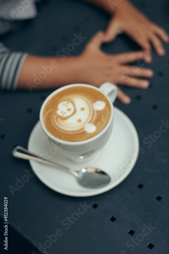 Close up of a coffee with a bear pattern made with milk photo