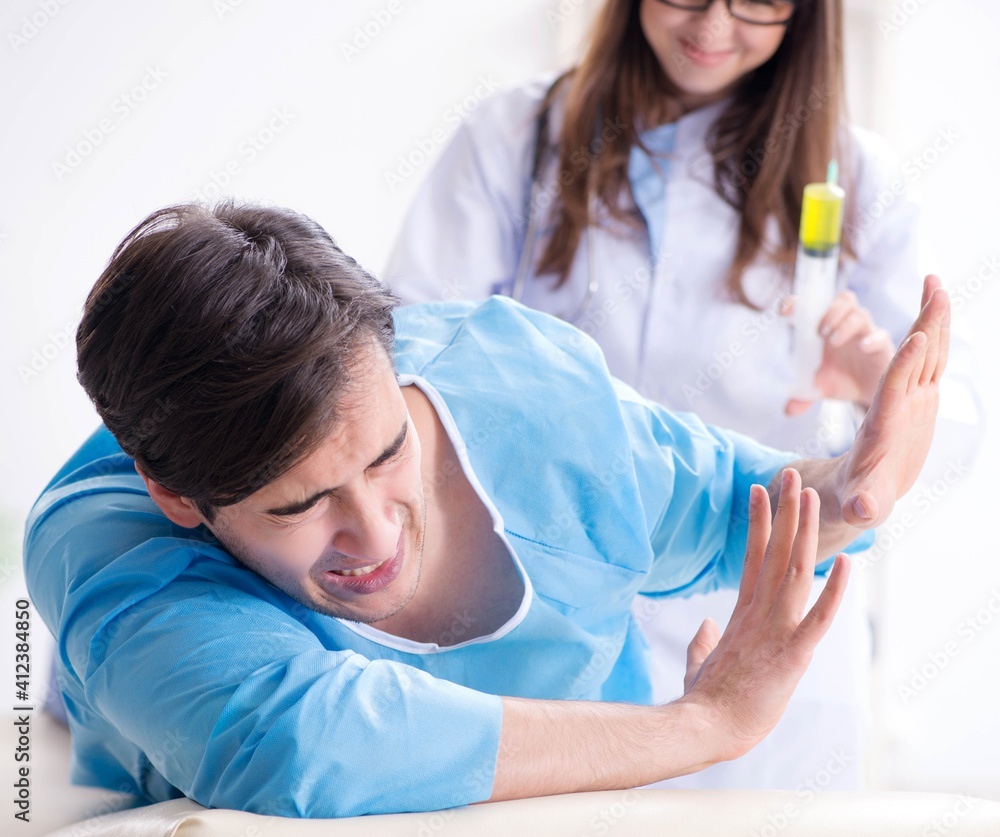 Fototapeta premium Funny man getting ready for buttocks syringe shot