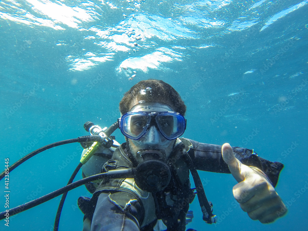 Young man self portrait scuba diving underwater Young man self portrait scuba diving underwater