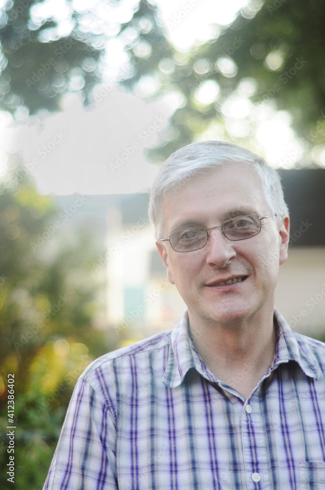 Gray haired man with glasses smiling Gray haired man with glasses smiling