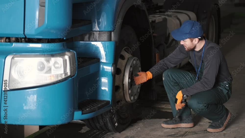 Technical engineer checking tire of a truck. Car repairment, service. Technical engineer checking tire of a truck. Car repairment, service.