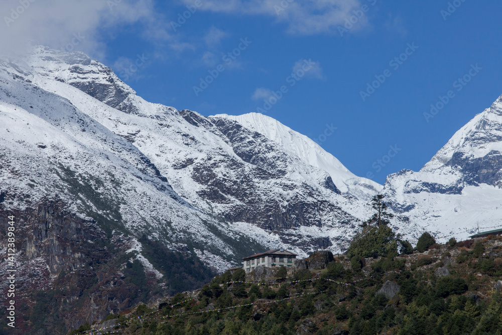 A house atop a hill overlooking the mountains in the everest region of the himalaya, Nepal. A house atop a hill overlooking the mountains in the everest region of the himalaya, Nepal.