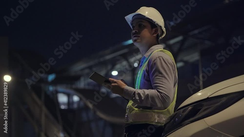 Civil engineer work inspecting architect drawing on construction site.