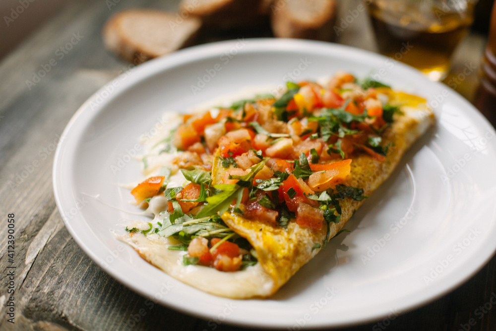 Omelette with fresh tomatoes, cheese and salad Omelette with fresh tomatoes, cheese and salad