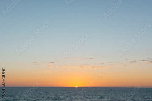 Sunset over calm ocean. California.