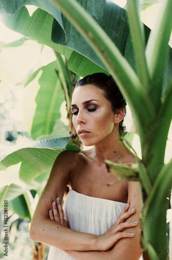 Woman standing among banana leaves Woman standing among banana leaves