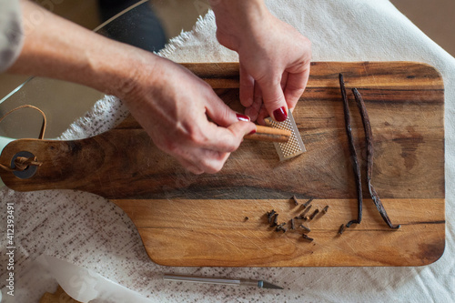 Woman is gratering cinnamon stick