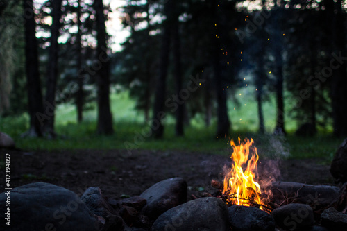 A campfire burns in the evening at a camp spot photo