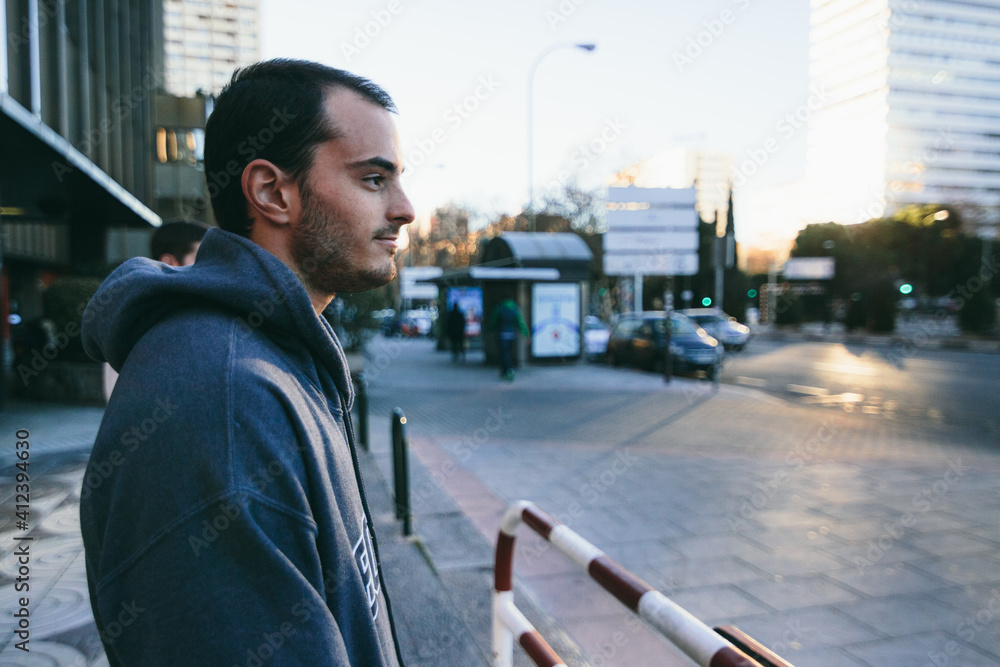 Man with a sweatshirt resting during a parkour training Man with a sweatshirt resting during a parkour training
