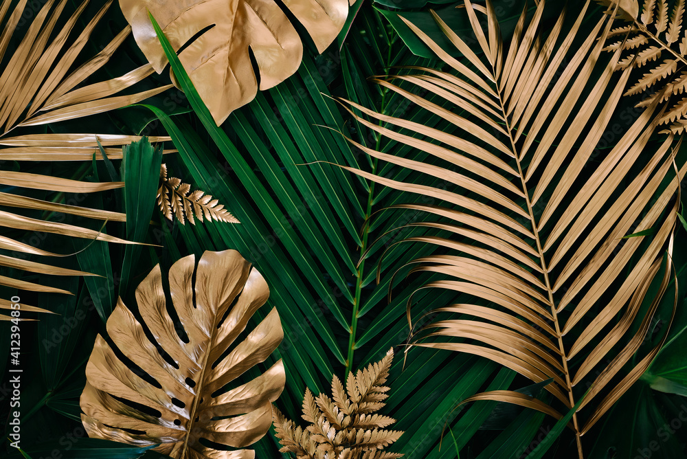 Creative nature background. Gold and green tropical Monstera and palm leaves. Minimal summer abstract jungle or forest pattern. - obrazy, fototapety, plakaty 