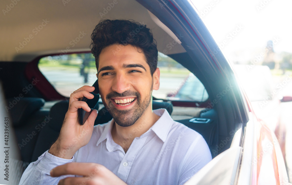 Businessman talking on phone in car. Businessman talking on phone in car.
