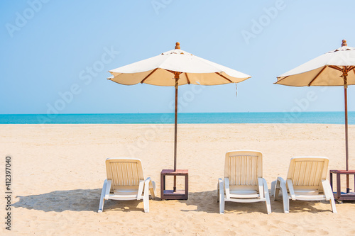 Fototapeta Naklejka Na Ścianę i Meble -  Umbrella and chair around beach sea ocean on blue sky
