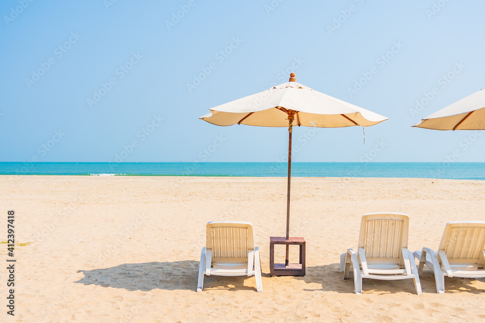 Umbrella and chair around beach sea ocean on blue sky Umbrella and chair around beach sea ocean on blue sky