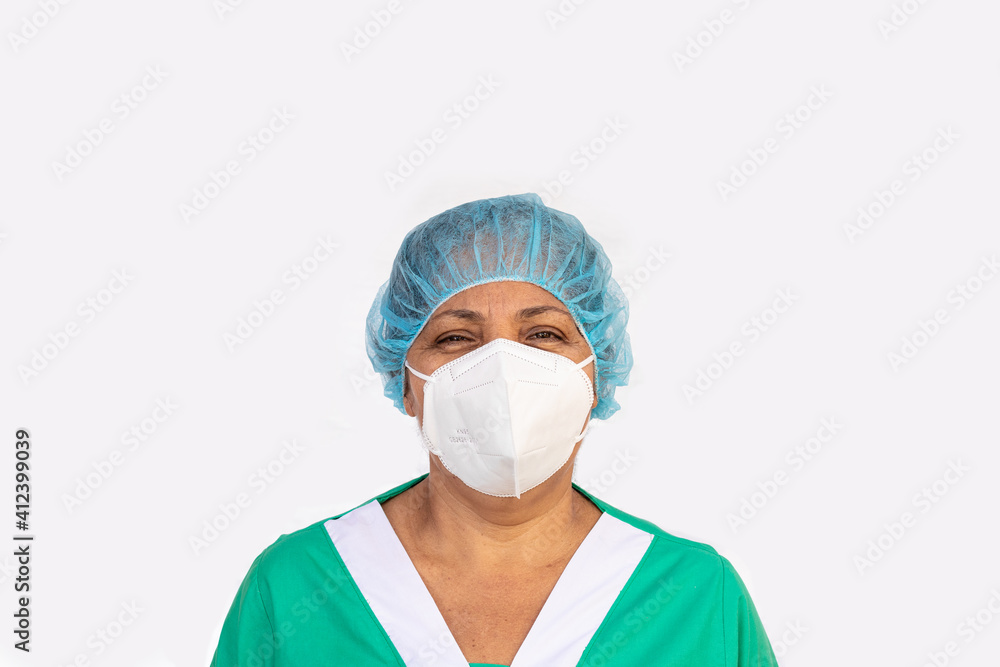 Latina nurse wearing hair net KN95 mask and medical scrubs clothes working in a hospital for the prevention of covid-19. Medical and health concept Latina nurse wearing hair net KN95 mask and medical scrubs clothes working in a hospital for the prevention of covid-19. Medical and health concept