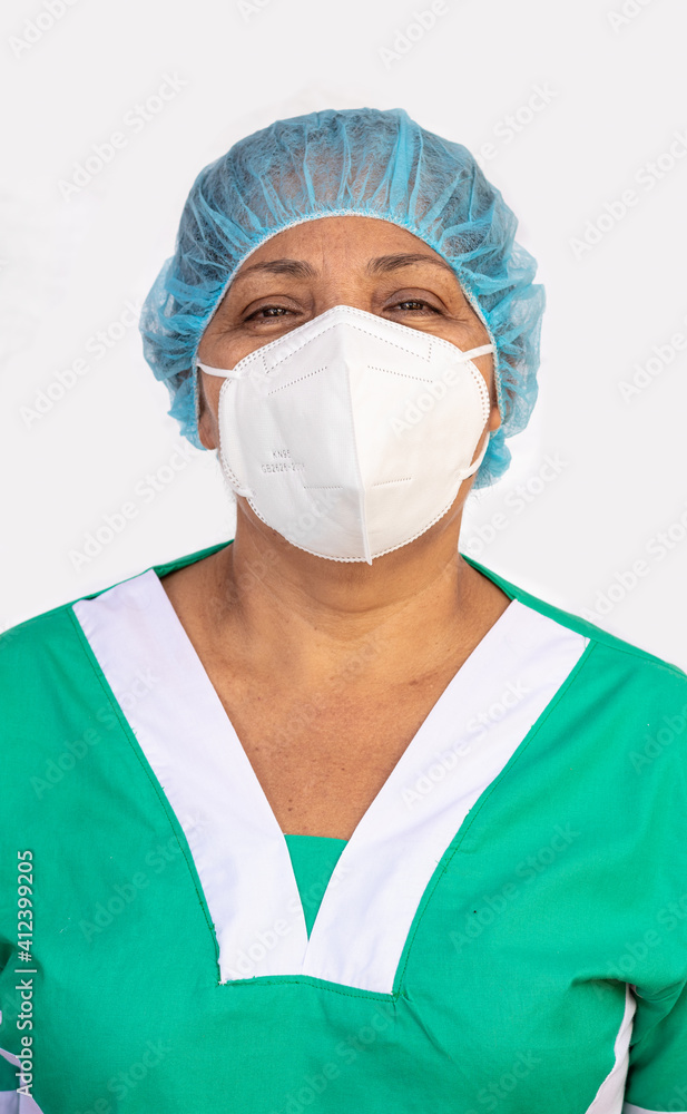 Latina nurse wearing hair net KN95 mask and medical scrubs clothes working in a hospital for the prevention of covid-19. Medical and health concept Latina nurse wearing hair net KN95 mask and medical scrubs clothes working in a hospital for the prevention of covid-19. Medical and health concept