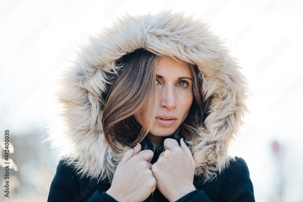 Portrait of a beautiful woman with a fur trim hood over her head Portrait of a beautiful woman with a fur trim hood over her head