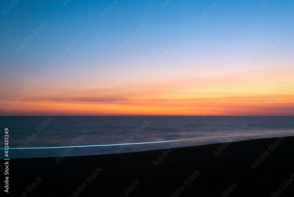 Fototapeta premium High tide and waves intensify in volcanic beach of Guatemala Monterrico at sunset, salt water, open air view.