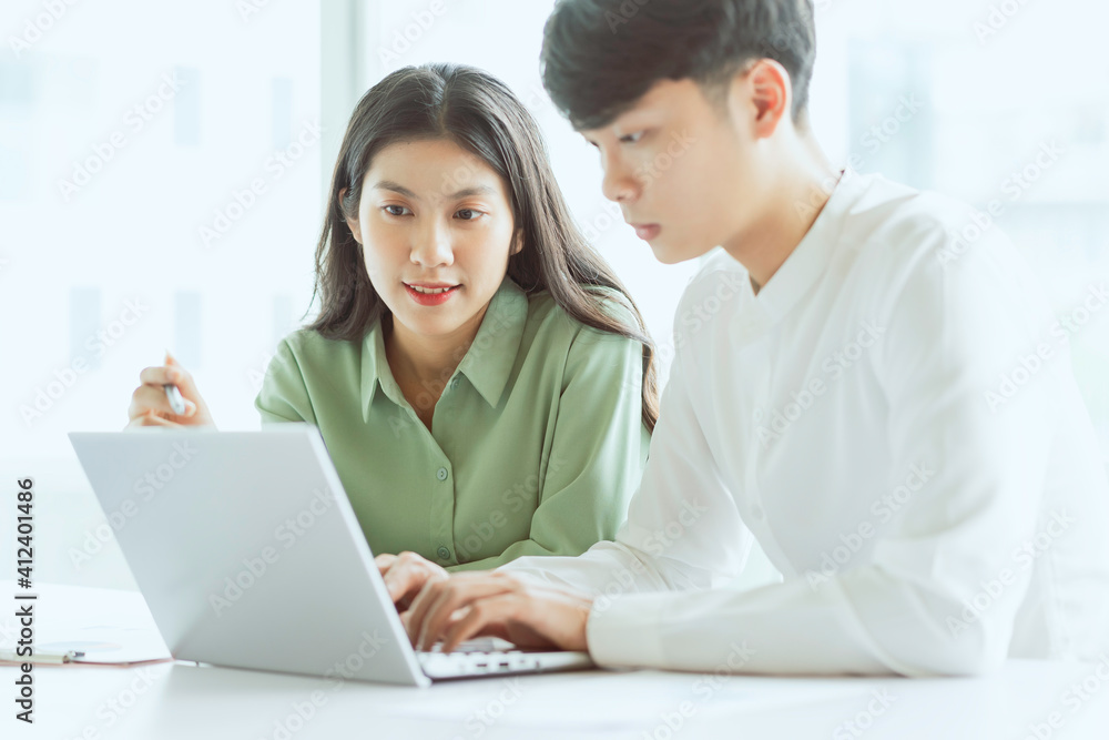 Young Asian business couple working together, completing the assigned work Young Asian business couple working together, completing the assigned work