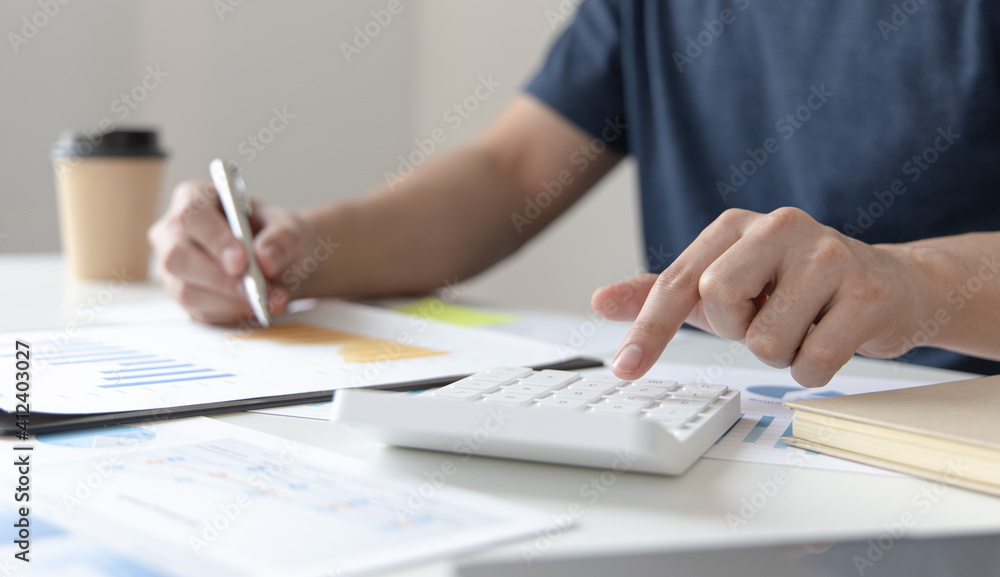 Financial businessman calculating corporate income tax data And analyzing charts of financial stocks that are in good condition with growth and progress, Investment in finance and accounting. Financial businessman calculating corporate income tax data And analyzing charts of financial stocks that are in good condition with growth and progress, Investment in finance and accounting.