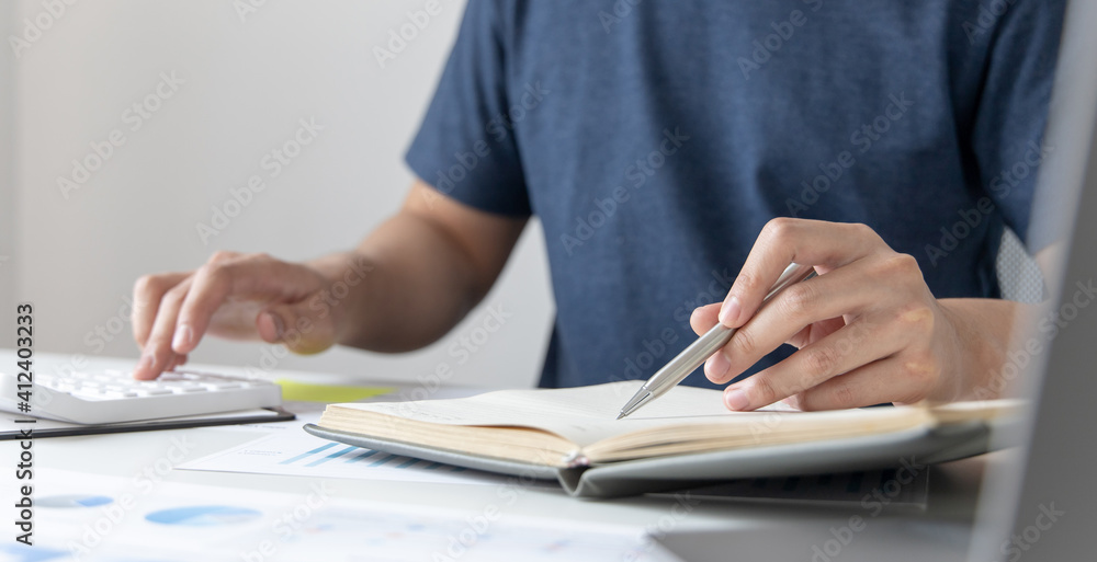 Head of accounting is recording the company's financial growth statistics using graphs as a reference for reviewing and analyzing the results, Taking notes and analyzing data graphs in office. Head of accounting is recording the company's financial growth statistics using graphs as a reference for reviewing and analyzing the results, Taking notes and analyzing data graphs in office.