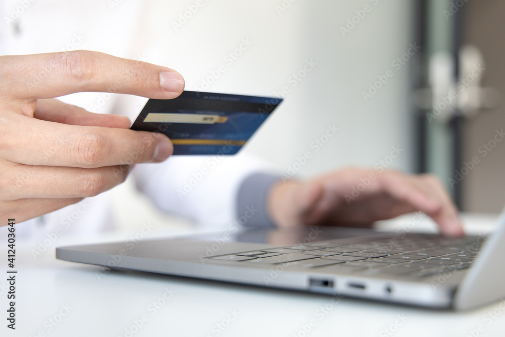 Online product purchase, Businessman use laptop register via credit cards to make online purchases, Shopping and mail, credit card online security, Online shopping concept. Online product purchase, Businessman use laptop register via credit cards to make online purchases, Shopping and mail, credit card online security, Online shopping concept.