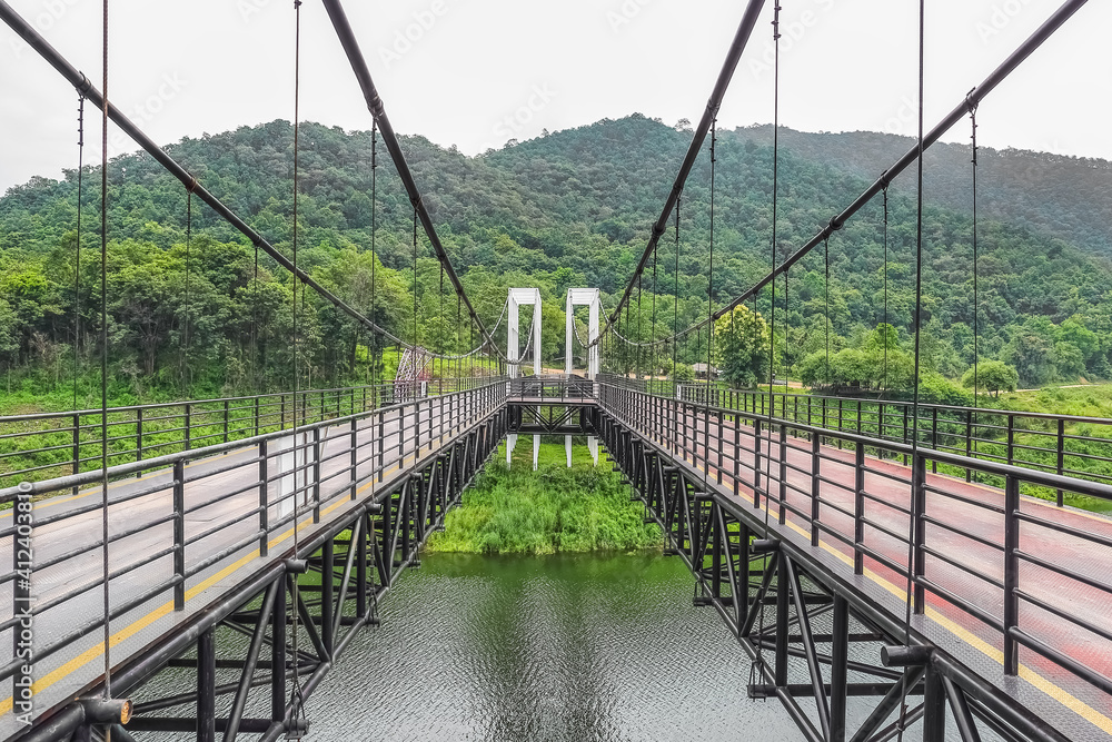Fototapeta premium Suspension bridge at Mae Kuang Udom Thara dam, Chiang mai Thailand.