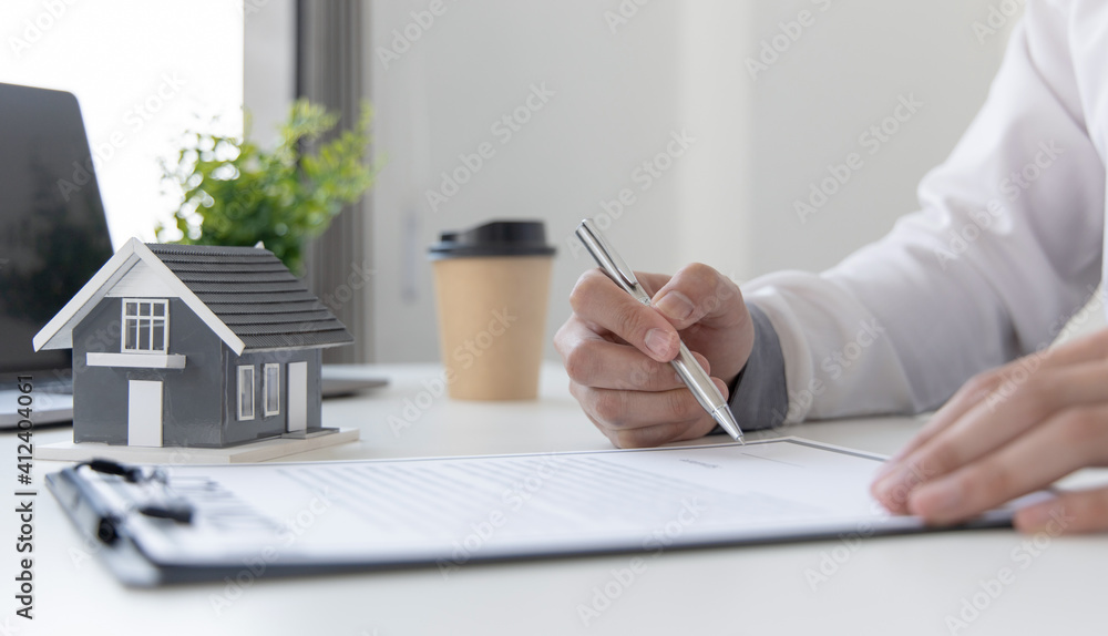 Fototapeta premium Sales manager or real estate agent will be prepared to show you a sample home and detail the terms of buying a home with insurance promotions, Attention to property services and insurance concept.