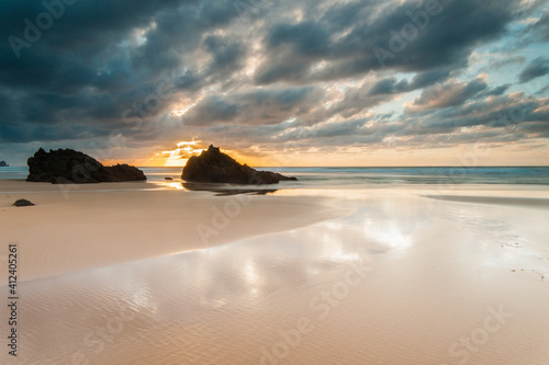 Sunset on a beach in northern Spain with a dramatic sky photo