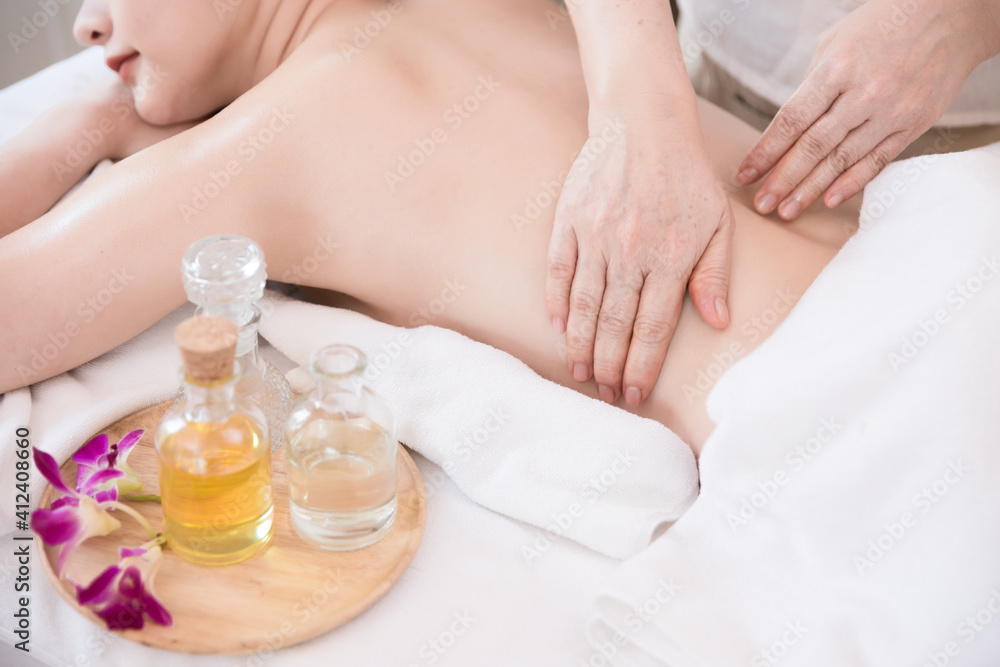 Fototapeta premium Young Asian woman getting Relaxing oil massage at beauty spa salon. Massage for health