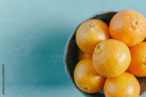 Tangelos in a bowl on a blue background photo