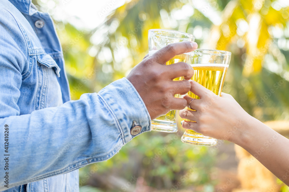 Two friends were happy toasting glasses and drinking beer on vacation. Two friends were happy toasting glasses and drinking beer on vacation.