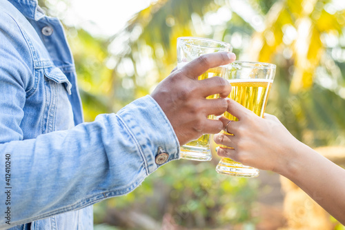 Two friends were happy toasting glasses and drinking beer on vacation.