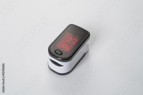 Portable digital fingertip oximeter isolated on white background (ID: 412410686)
