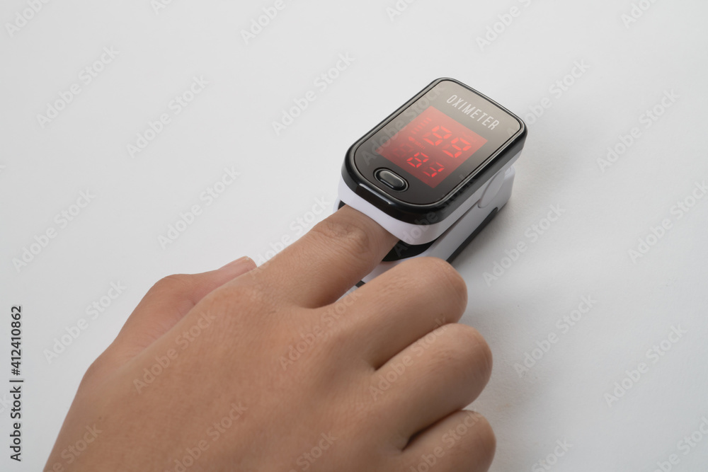 Pulse Oximeter, finger digital device to measure person's oxygen saturation. Reduced oxygenation is an emergency sign of pneumonia caused by flu or novel coronavirus. Device on Fingertip Pulse Oximeter, finger digital device to measure person's oxygen saturation. Reduced oxygenation is an emergency sign of pneumonia caused by flu or novel coronavirus. Device on Fingertip
