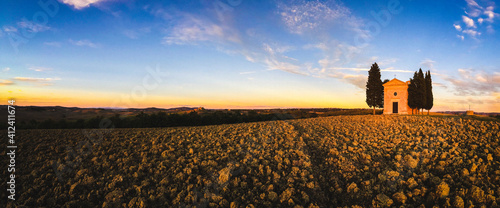 a little church in the middle of a typical Tuscany landscape photo