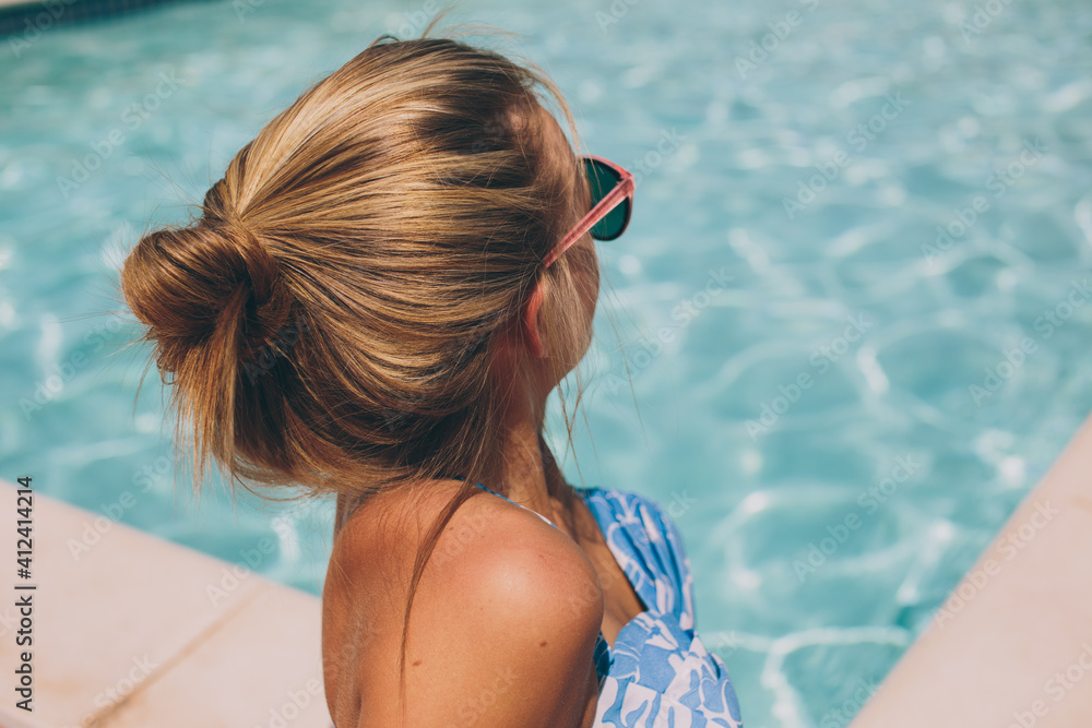 Girl Sitting at Edge of a Swimming Pool Girl Sitting at Edge of a Swimming Pool