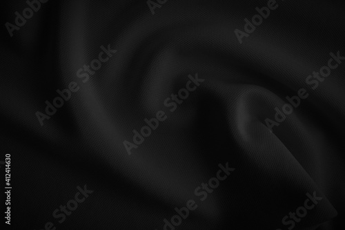 Black wavy cloth. Dark tone fabric background