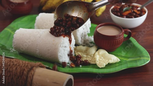 Rice Puttu white Pittu , Kadala Chickpea curry , milk tea , popular South Indian breakfast steamed rice cake 4K slow motion video footage Kerala Tamil Nadu India Sri Lanka. rice flour grated coconut   photo