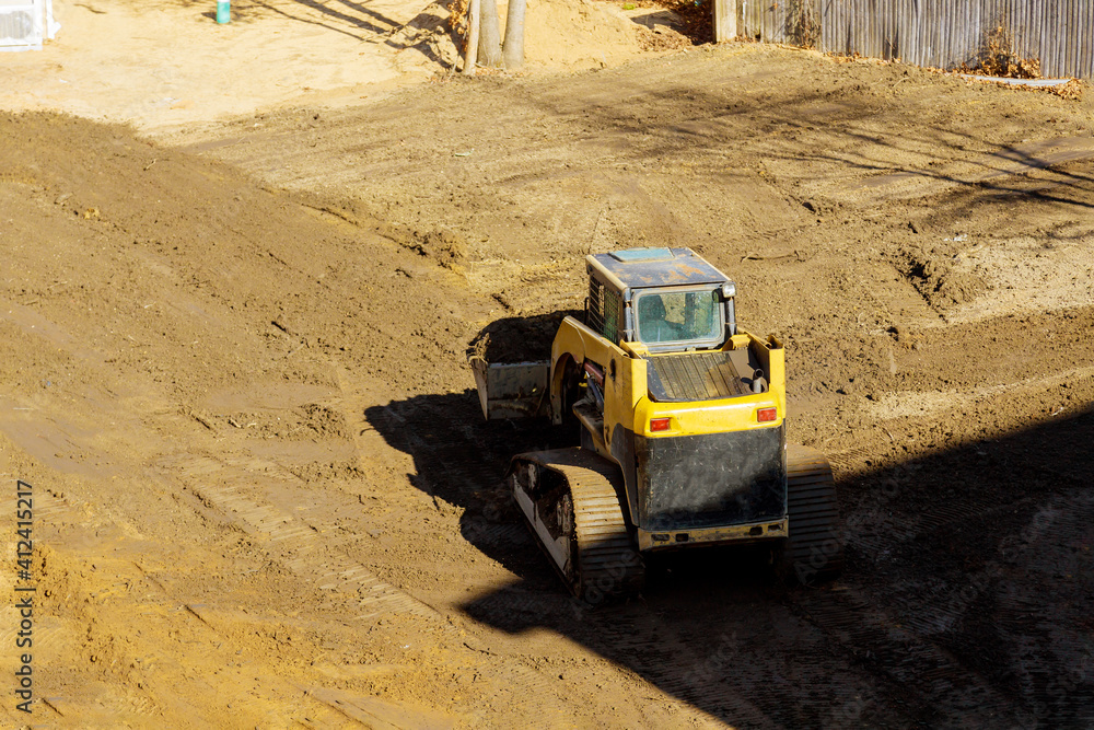 Small tractor digging land working with land Small tractor digging land working with land