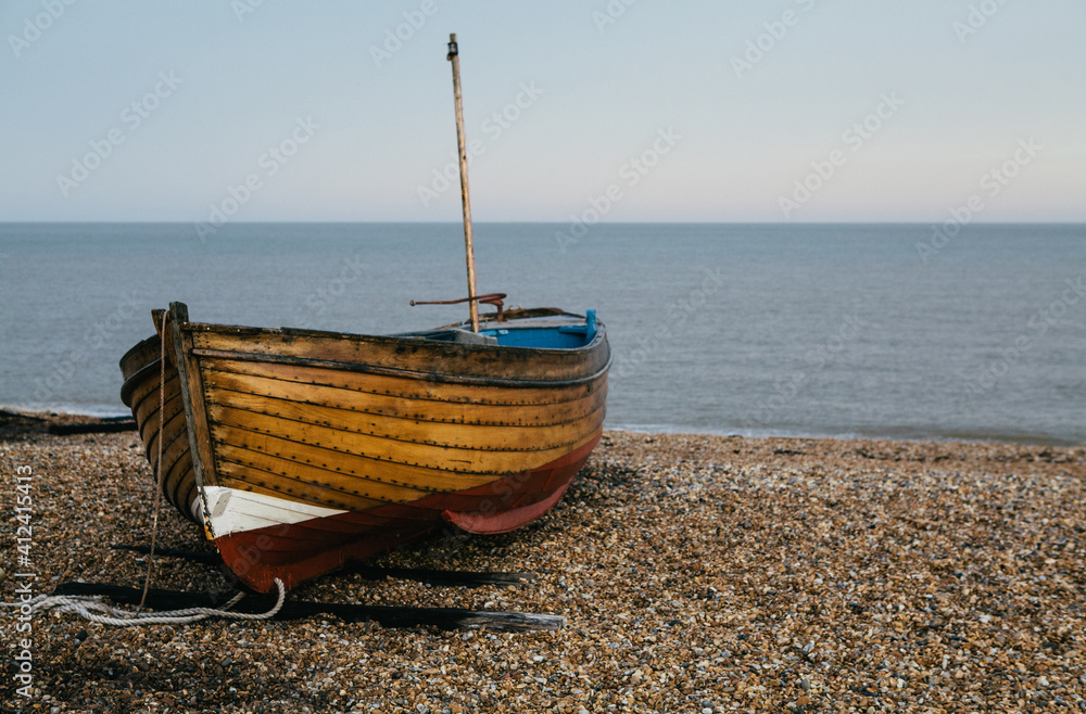 Traditional small wooden fishing boat on the shore. Traditional small wooden fishing boat on the shore.
