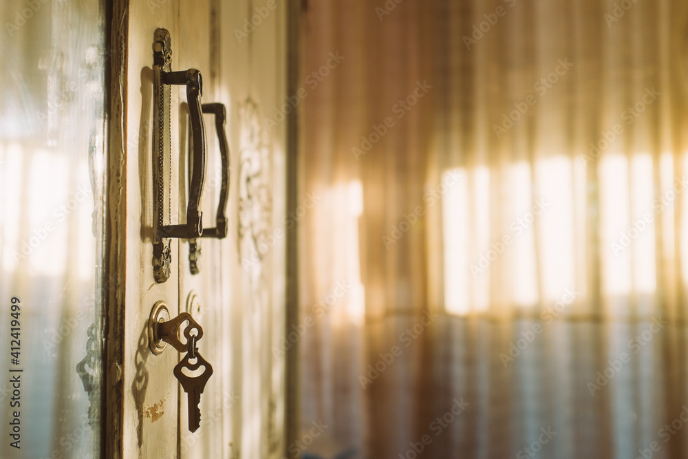 Keys hang from door in sunlight room Keys hang from door in sunlight room