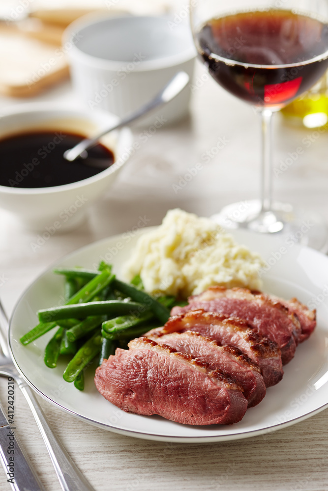 Tasty sliced duck meat with garnish on white plate Tasty sliced duck meat with garnish on white plate