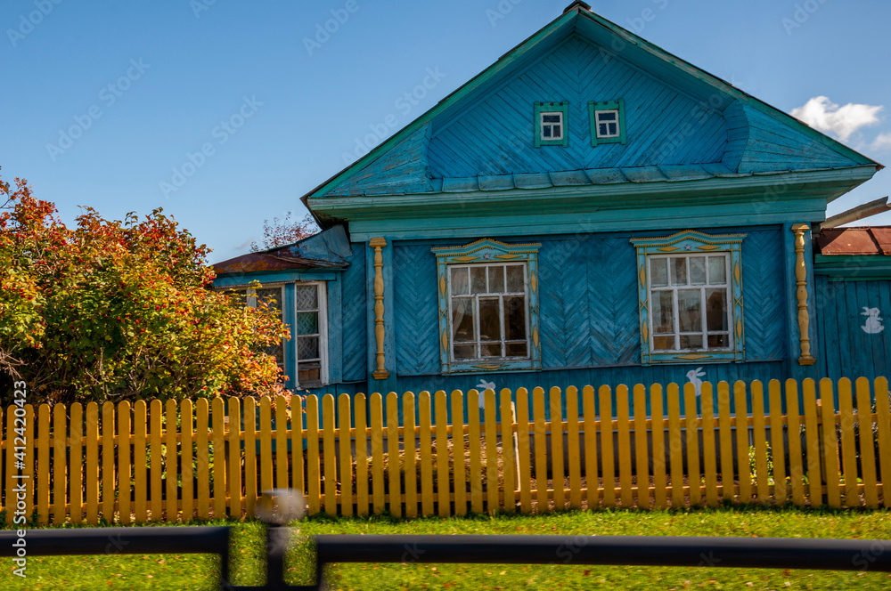 Autumn sky over  village with small wood colored local house and low fence in the mountains and fields. Travelling on the suburb roads. People living