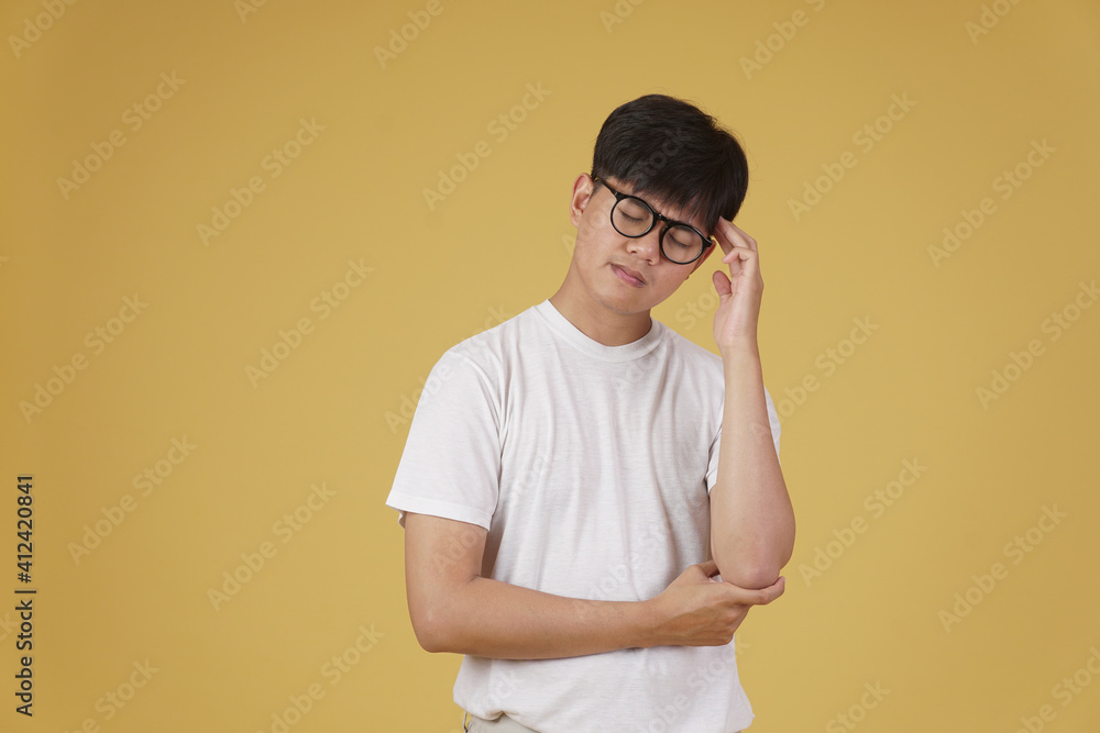 portrait of thoughtful young asian man dressed casually thinking doubting wondering isolated on yellow background portrait of thoughtful young asian man dressed casually thinking doubting wondering isolated on yellow background