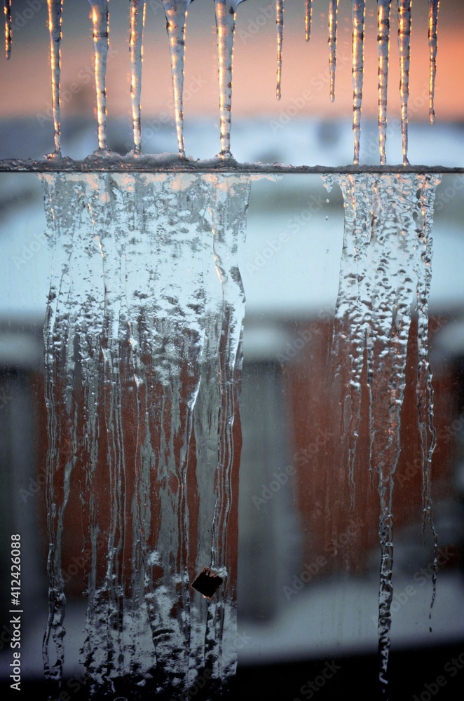 stalactites of ice in front of sunset stalactites of ice in front of sunset