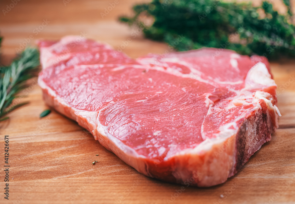 Raw steak on cutting board Raw steak on cutting board